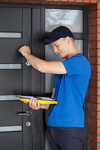 a man holding a clipboard and knocking on a door