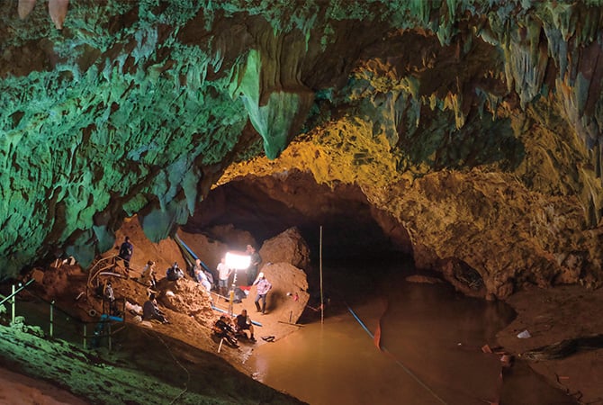 Image of cave divers searching through a large cave