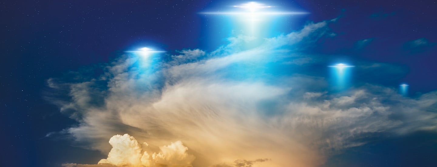 the bright lights of three hovering UFOS in the night sky