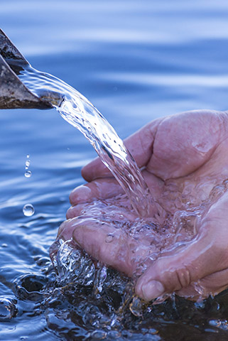 water running into cupped hands