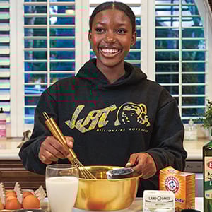 Image of a teen smiling and baking
