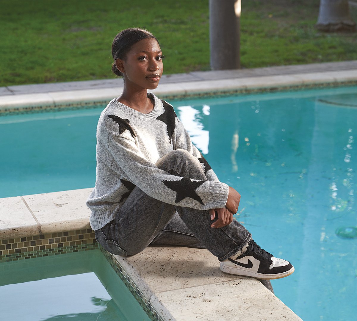 Image of a teen posing by a pool