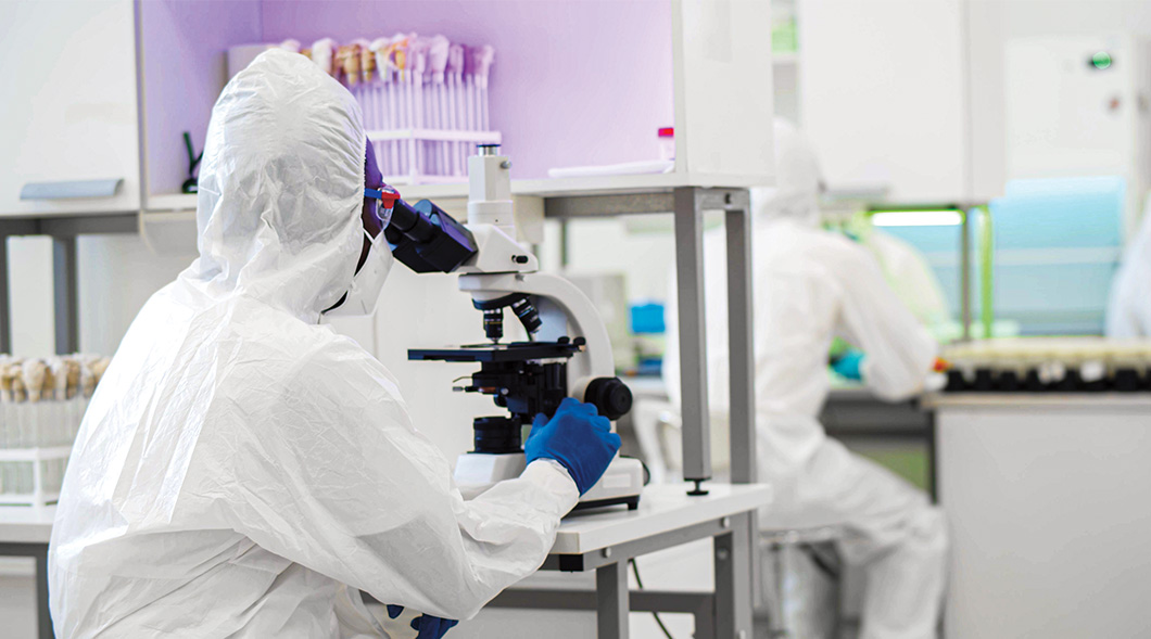 Photo of a scientist using a microscope