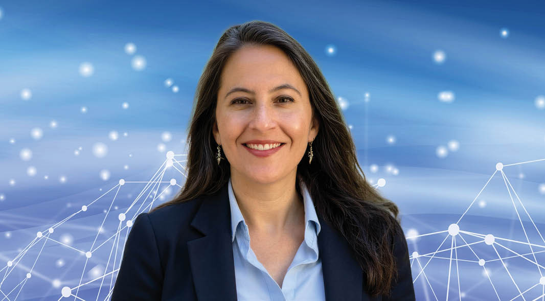 A woman poses in front of a blue background with a digital network pattern